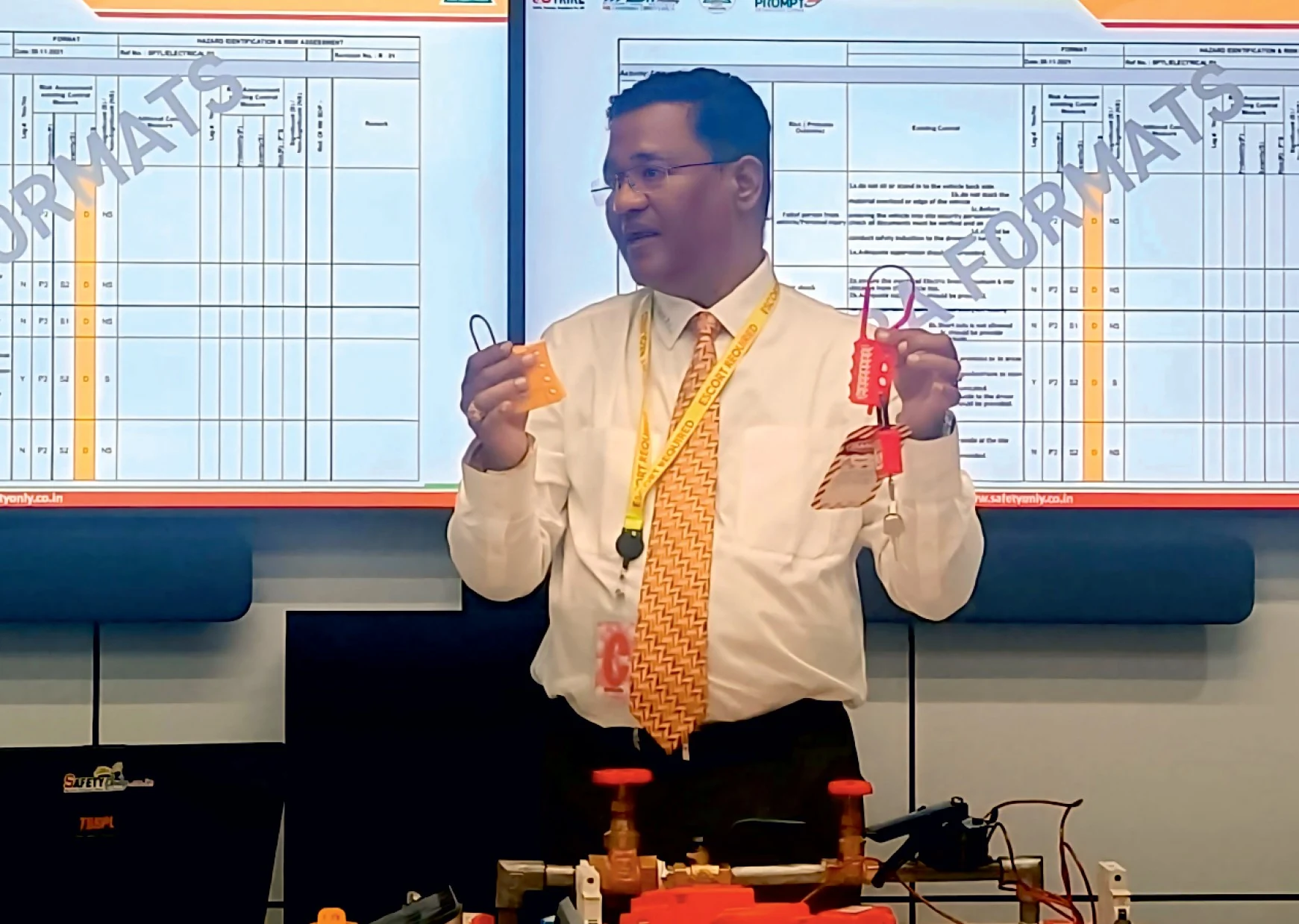 Mr. Rajnikant Teli demonstrating industrial safety equipment